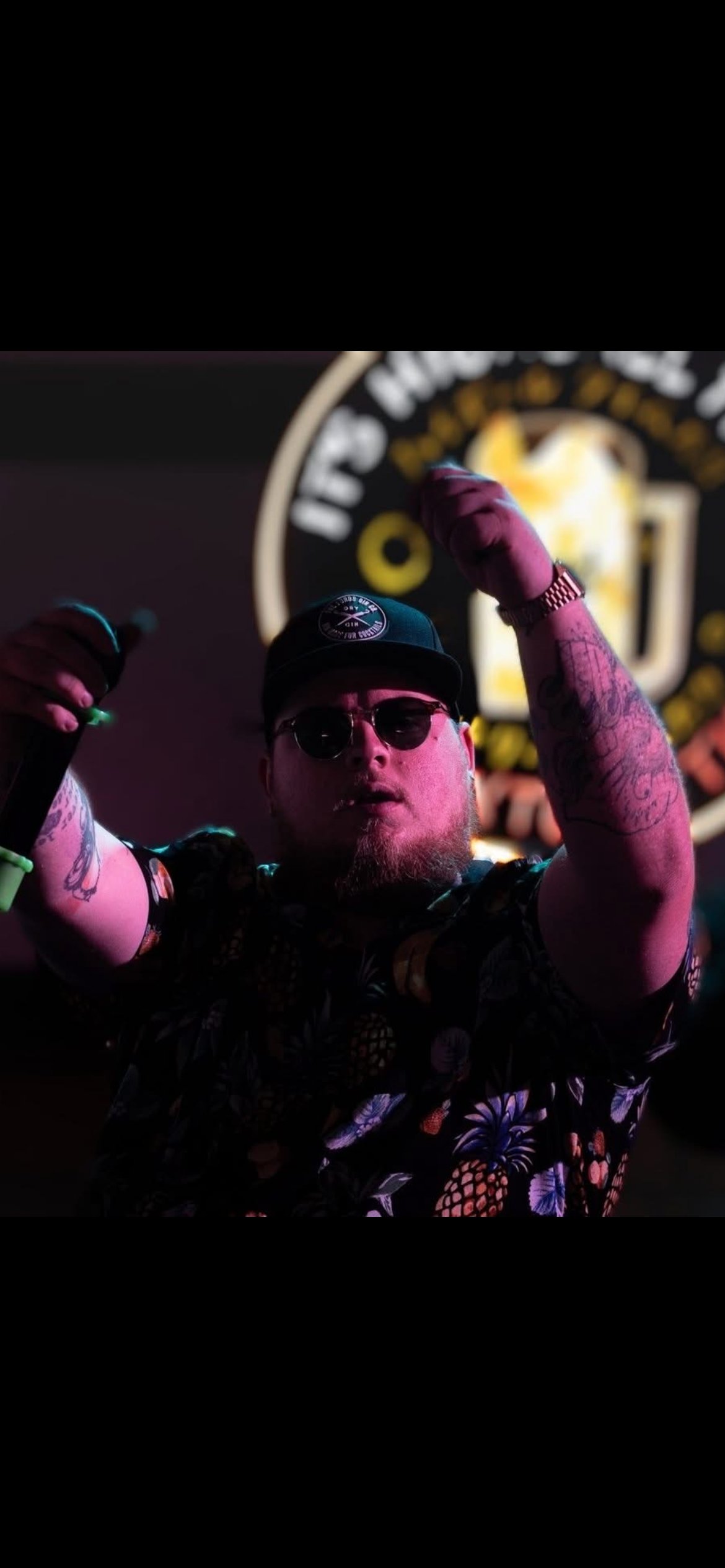 KJ Kevvy hosting karaoke on stage with microphone